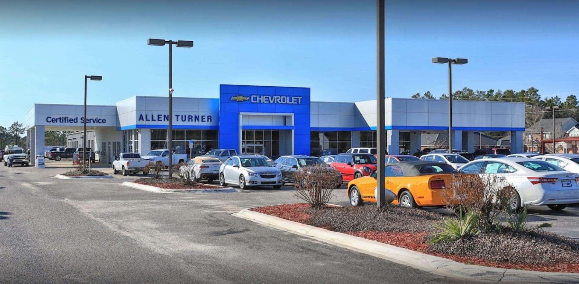 An exterior shot of our new Chevy and used car dealership in Crestview, FL with inventory