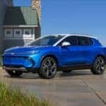 A blue 2024 Chevrolet Equinox parked by the sea
