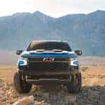 2024 Chevy Silverado in blue on an open plain