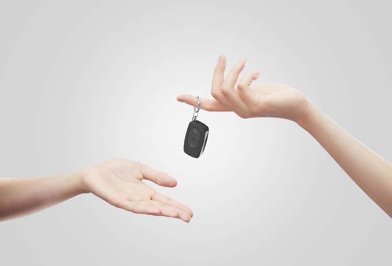 Person handing keys to another
