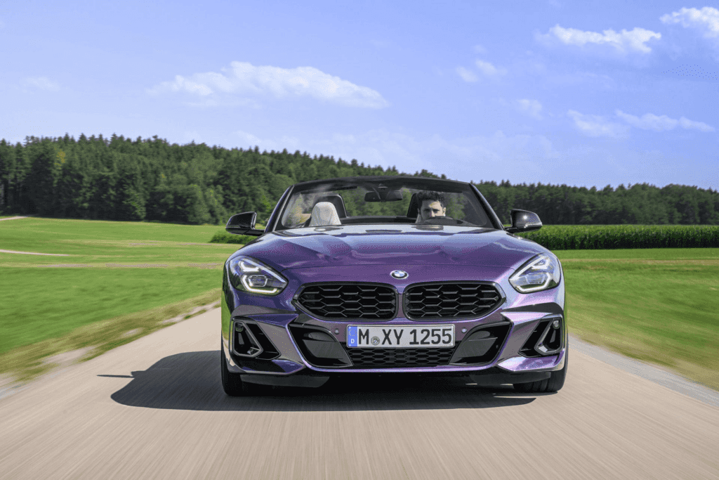 A front view of a 2023 BMW Z4 driving down a country road