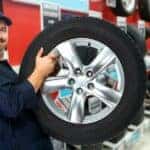Car mechanic with tire