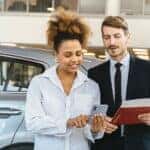 Looking at phone in car dealership