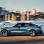 A BMW EV driving along a cityscape
