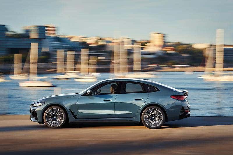 A BMW EV driving along a cityscape