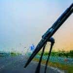 A BMW service windshield wiper clearing a wet windshield
