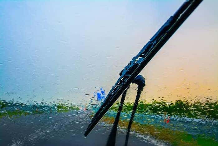A BMW service windshield wiper clearing a wet windshield