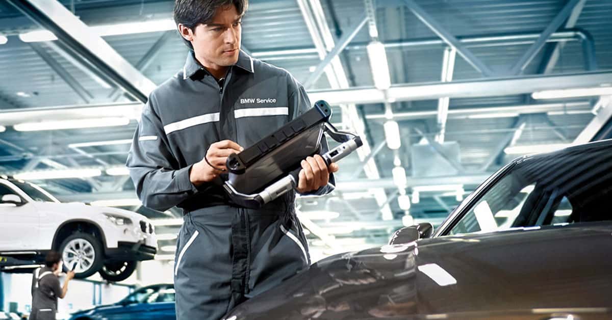 Service technician inspecting BMW warranty coverage