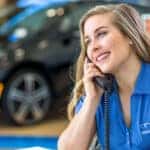 Salesperson answering the phone at a BMW dealership in Wesley Chapel, FL