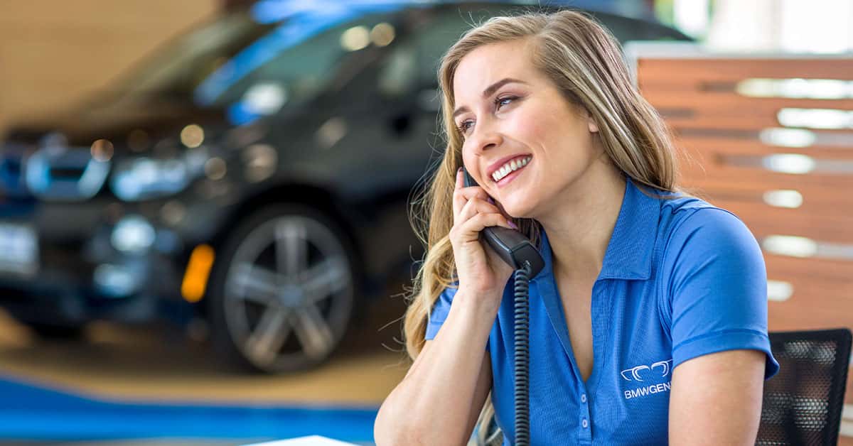 Salesperson answering the phone at a BMW dealership in Wesley Chapel, FL