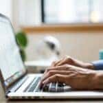 Person shopping for BMW parts online at a laptop