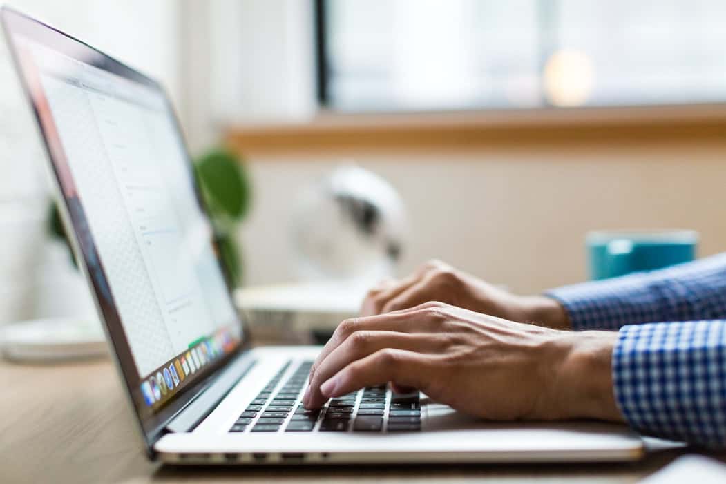 Person shopping for BMW parts online at a laptop