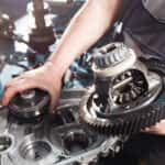 BMW parts technician working on a transmission