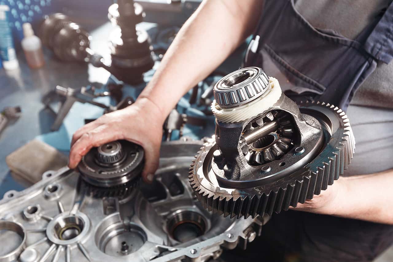 BMW parts technician working on a transmission