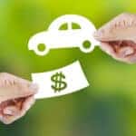 Cash and keys exchanging hands as part of BMW trade-in
