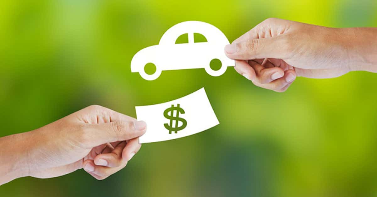 Cash and keys exchanging hands as part of BMW trade-in