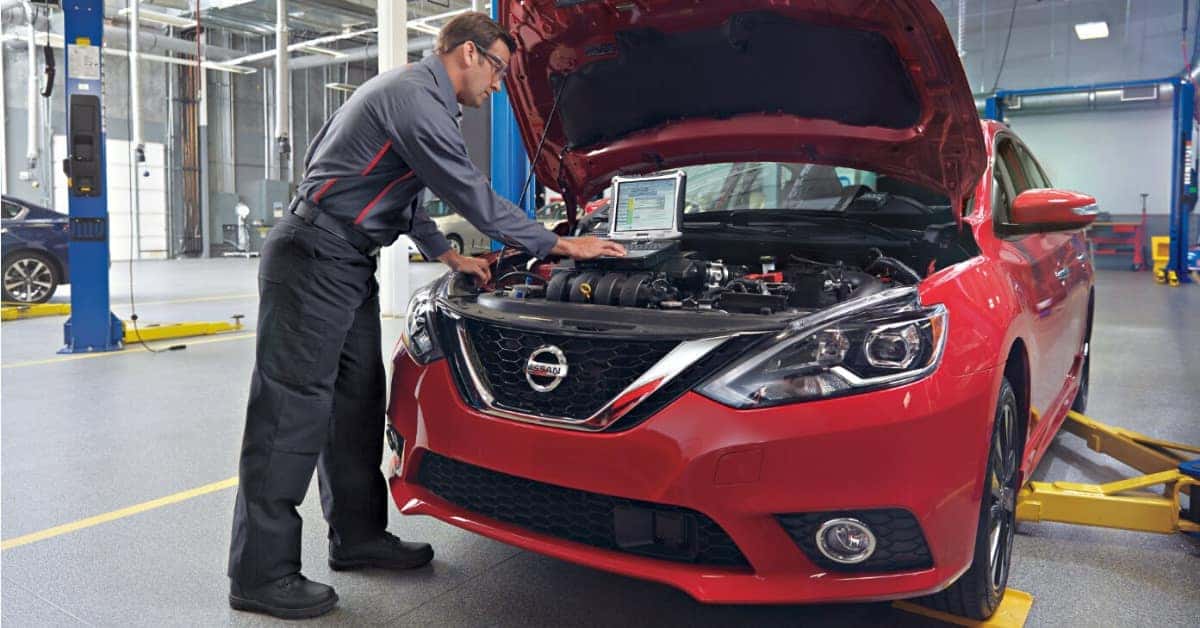 Mechanic running tests on Nissan Sentra