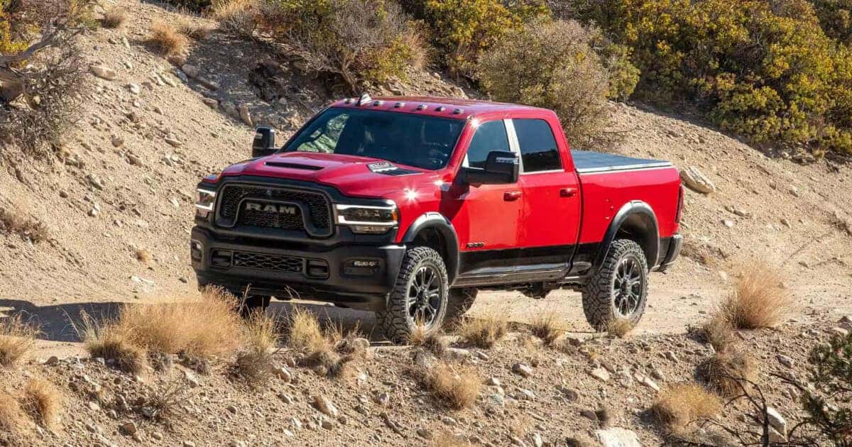 Custom 2024 RAM 2500 driving through arid terrain