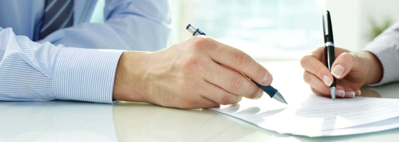 Man and Woman Signing Contract