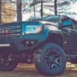 A black GMC Sierra lifted truck from a local dealer
