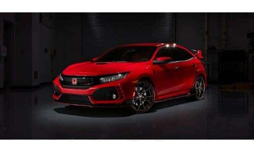 2019 Honda Civic Type R exterior showcase shot in a dimly lit garage with red paint color