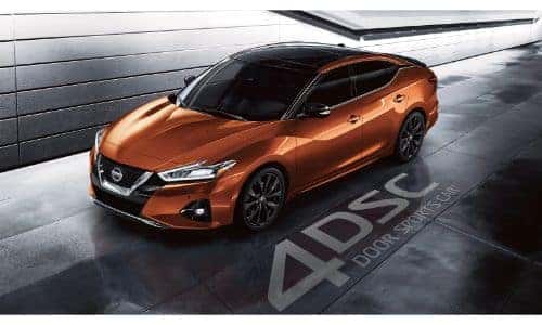 2020 Nissan Maxima exterior overhead shot with dark orange paint color in an underground tunnel