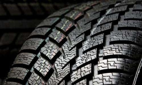 a closeup shot of a brand-new, fresh and clean tire with its tread pattern