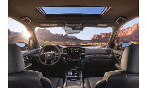 2019 Honda Passport interior shot of front seating, steering wheel, dashboard, and sunroof layout and design