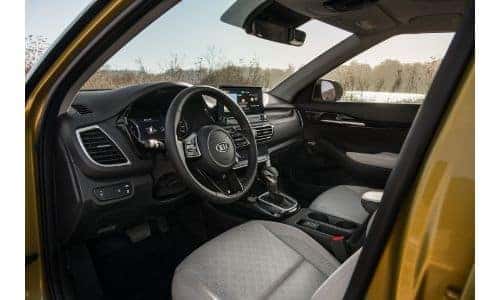 2021 Kia Seltos interior shot of driver's seat, steering wheel, and dashboard design and layout