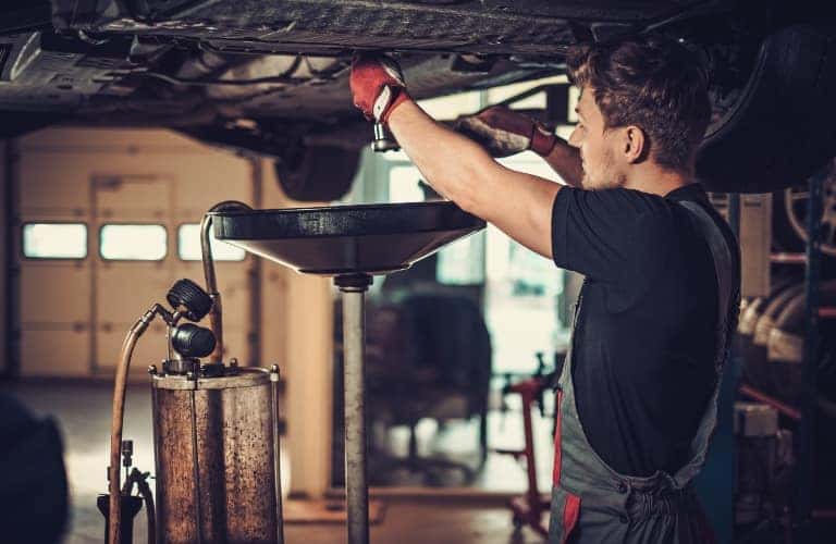 Car Mechanic doing an oil change