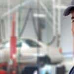 Car mechanic with car in background