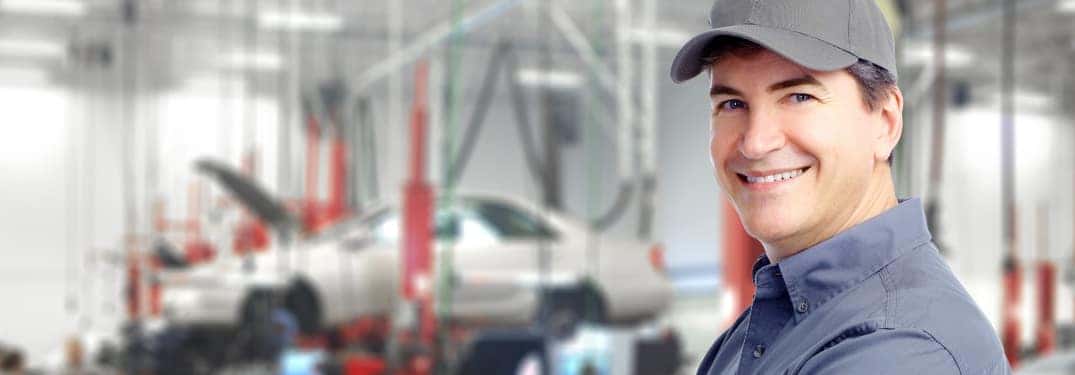 Car mechanic with car in background