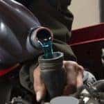 man pouring antifreeze into a cooling system