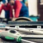 tools on a table with two people in the background