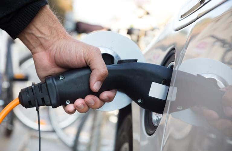Electric car charger plug held in a hand
