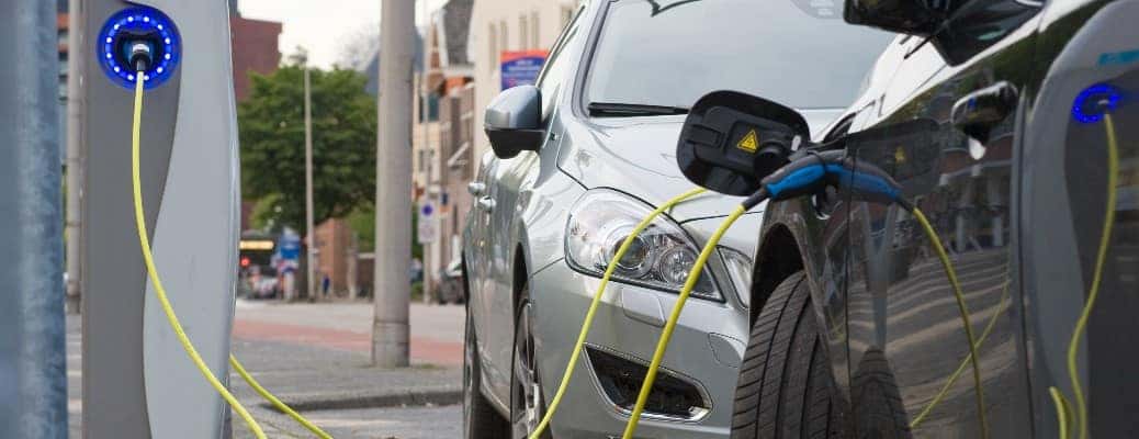 two cars at a public charging station