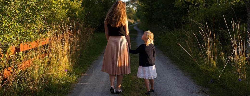 a mom with a kid in a field