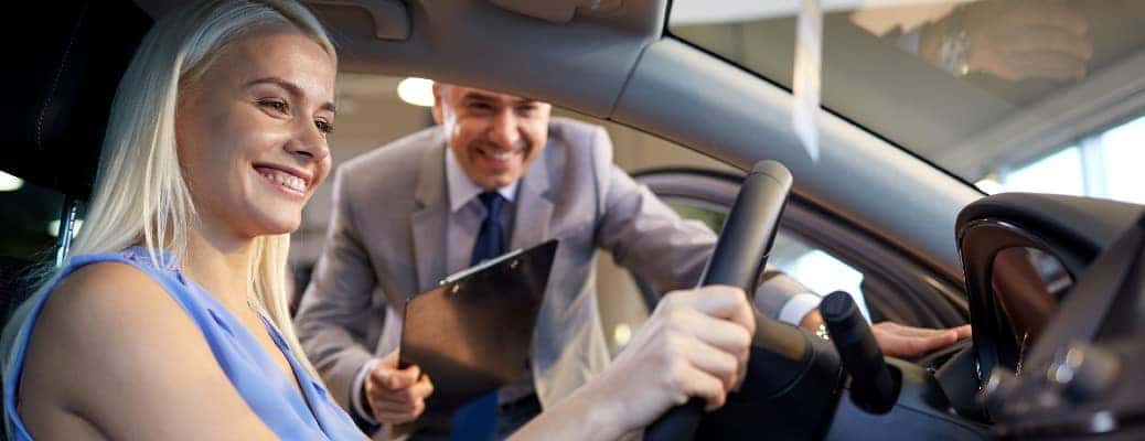A man and a woman at a dealership