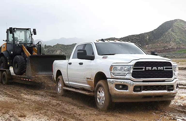 2023 Ram 2500 truck towing a tractor