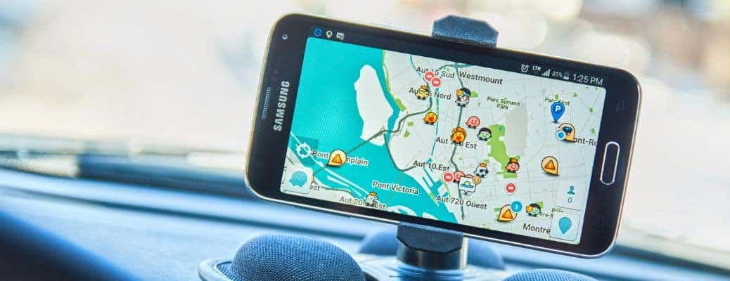 a Samsung phone showing a map in a phone holder in a car