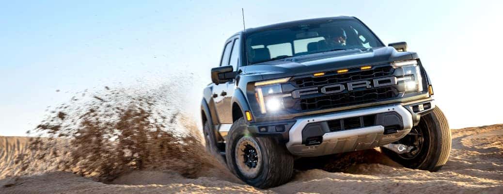 2024 Ford F-150 Raptor driving through sand