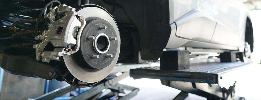 the exposed brakes of a white vehicle