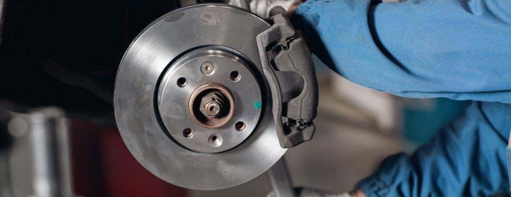 exposed vehicle brakes with a worker