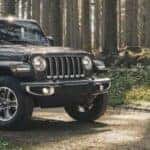 2020 Jeep Wrangler by two people on a forested road