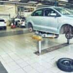 cars in a service center lifted in the air