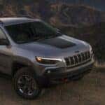 2021 Jeep Cherokee front and side view on a dirt road