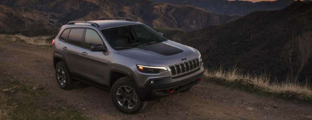2021 Jeep Cherokee front and side view on a dirt road