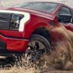 2024 Ford F-150 Lightning pickup truck in red off-road
