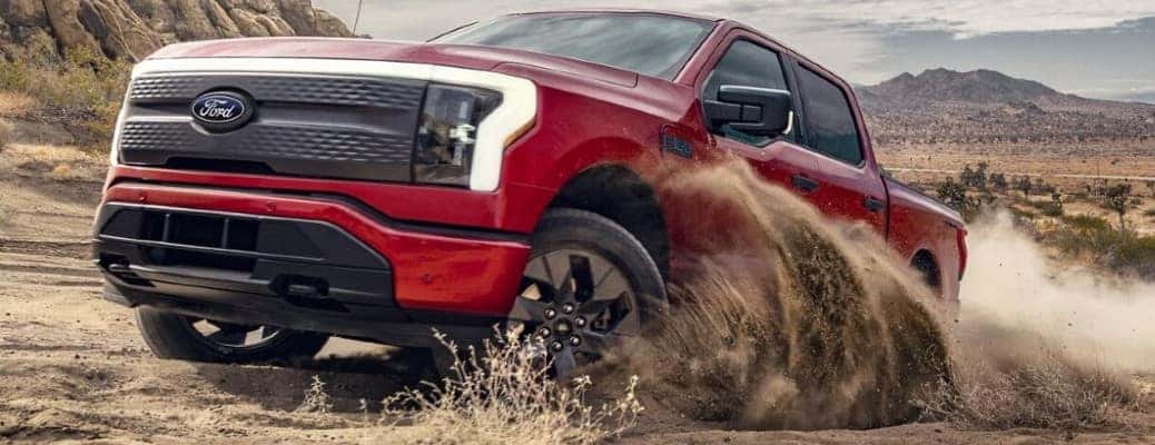 2024 Ford F-150 Lightning pickup truck in red off-road