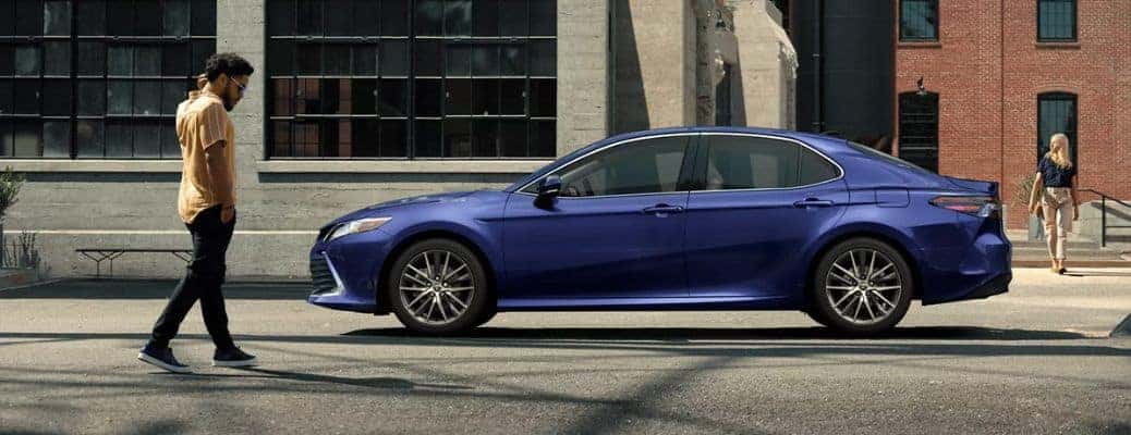2022 Toyota Camry side view with a person on a street